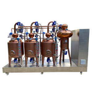three red copper pot stills, one heat exchanger, one control cabinet, and accessories installed on a skid with casters